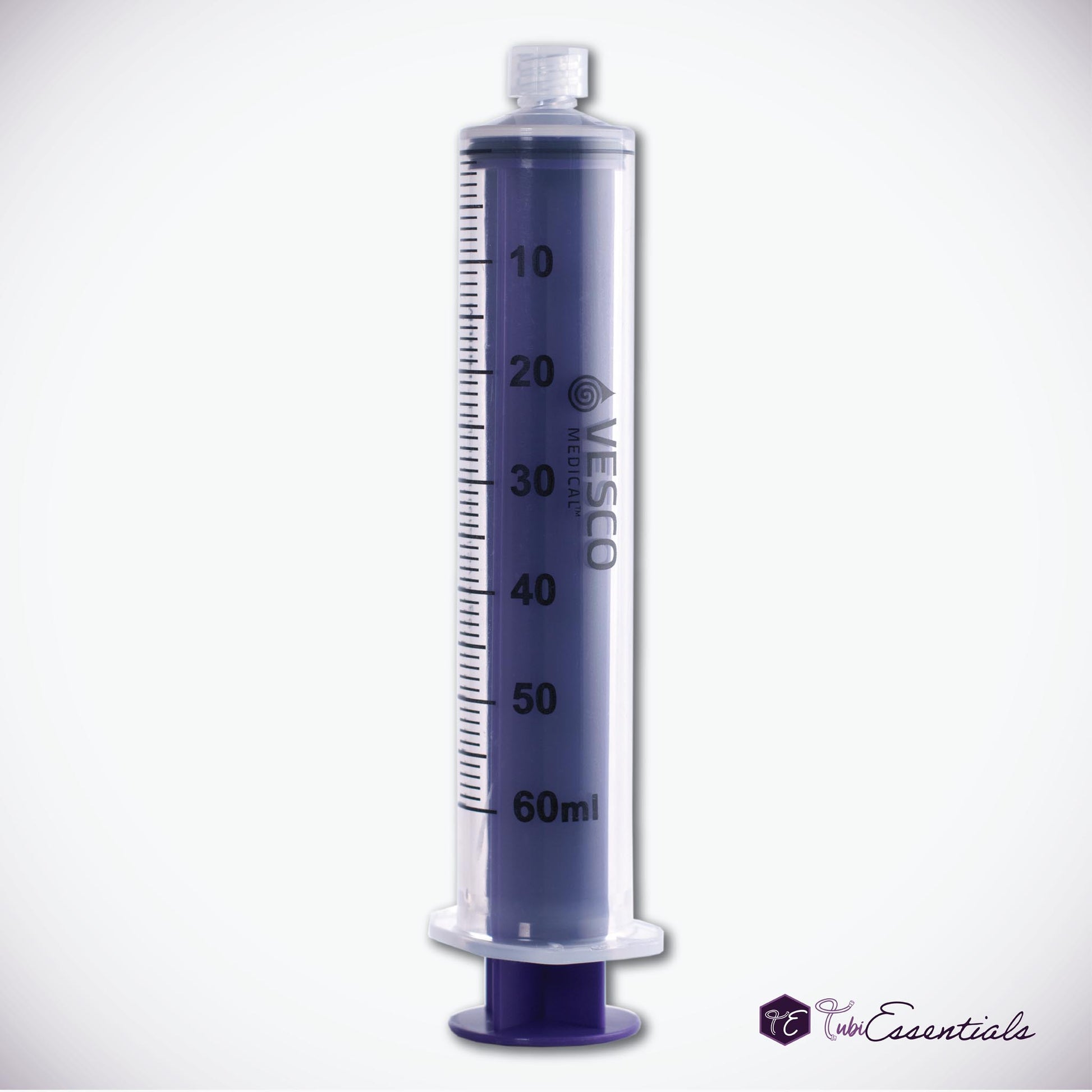 Reusable 60mL Enteral ENFit Syringe with a clear barrel, black graduation markings, and a purple plunger placed on a White Background. The TubiEssentials Logo is located in the bottom right corner.